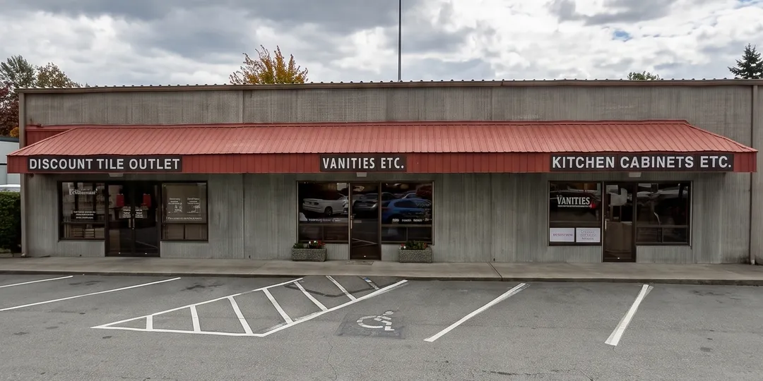The storefront at 1405 132nd Ave NE: Discount Tile Outlet, Vanities Etc. and Kitchen Cabinets Etc.